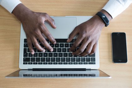 A top-down view of someone writing on a keyboard