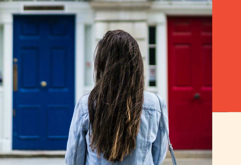 A woman with long brunette hair stands back on in front of a house. Image for a blog post on debt relief: credit counsellors vs debt repayment agents.