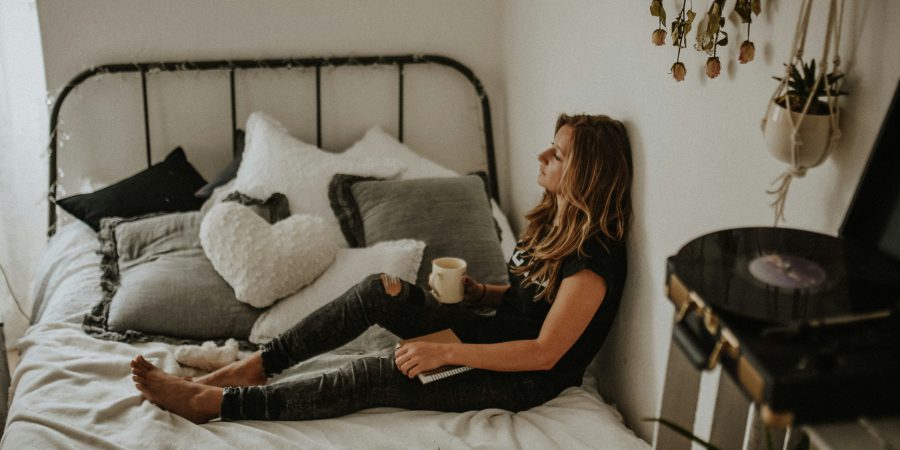 Woman sitting on bed - Regulator helps BC consumer out of an unlawful $7,000 air purifier contract